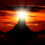 A person is standing in front of the sun.