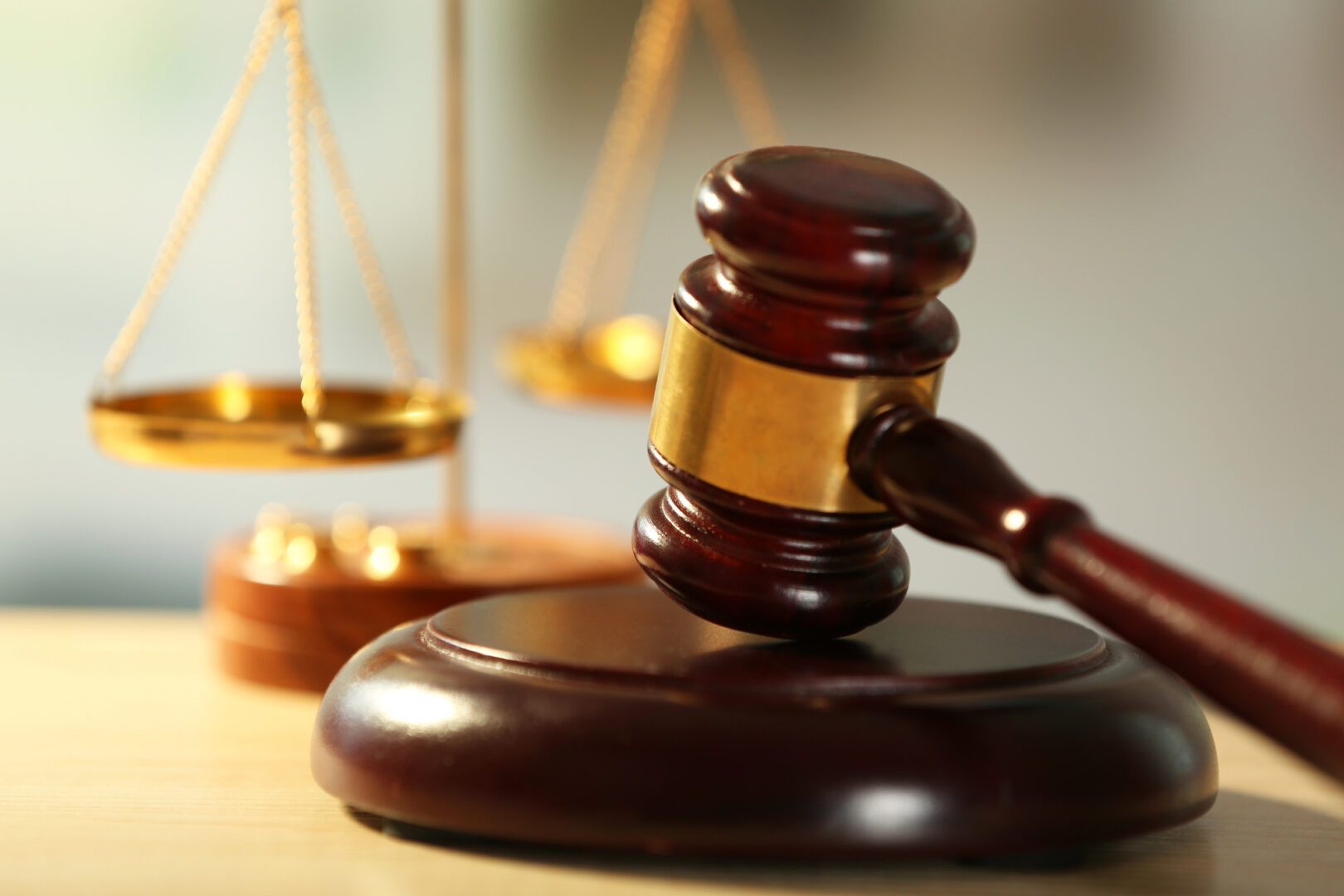 A judge 's gavel and scale of justice on top of a table.