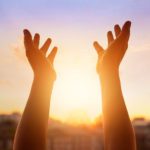A person with their hands up in the air.