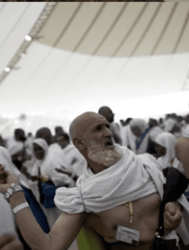 A man with white beard and head covering