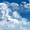 A blue sky filled with lots of fluffy clouds.