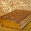 A wooden box with a gold background