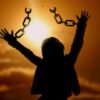 A person with their arms in the air and chains hanging from them.